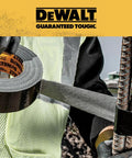 Person using Ultra Tough Duct Tape Heavy Duty All Weather Black 1.88 Inch By 30 Yard Rolls Pack Of 12 Aggressive Adhesive for repairs.