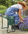 Gardener using Do It All Garden Kneeler Seat With Padded Cushion And Detachable Tool Bag, versatile foldable garden stool.