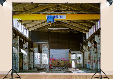 20X10FT Polyester Fabric Abandoned Industrial Warehouse Crane Graffiti Backdrop with urban decay elements in studio setup.