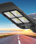 Solar Street Light 300W Outdoor Flood Light With 30000LM LED, weatherproof aluminum housing on road at dusk.