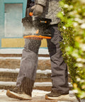 Person using a 20V Cordless Seed Spreader With 6 Speed Settings And 5 Ft Spreading Distance For Lawns on snowy steps.