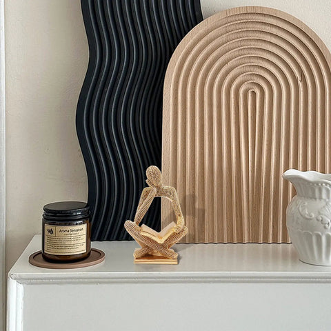 Sparkling Gold Tone Reading Woman Statue With Beaded Surface Modern Abstract Figurine on shelf with decor items