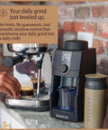 Pro Tier Stepless Grind Adjustment Coffee Grinder Featuring Precision Steel Burrs And Quick Release Design For Smooth Shot Pulling Or Effortless Daily Brewing In Slick Black Finish on a kitchen counter.