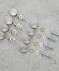 Heavy Duty Mirror Screw Caps With Stainless Steel Decorative Hardware, silver covers, and copper silicone washers on a grey surface.