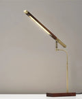 Barrett LED Desk Lamp With Dope Adjustable Walnut Wood Shade, 16.5 To 28.5 Inch Range, side view on white desk.