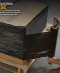 Smooth Operator Heavy Duty Black Stretch Wrap Roll With Handles 15 Inch 1000 Foot 60 Gauge used for wrapping a box securely.