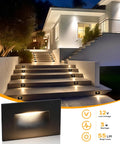 12V Low Voltage Indoor Outdoor Smart LED Step Lights for homes and decks illuminating a staircase at night, 6 pack shown