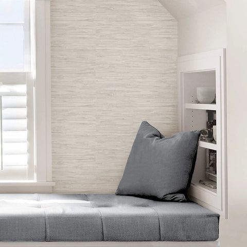 Cream Vinyl Grassweave Peel And Stick Wallpaper for Easy DIY Accent Walls shown in cozy reading nook.