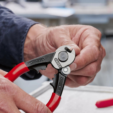 Close-up of All In One Wire Rope Cutter And Crimper With End Cap And Ferrule Dies For Bowden Cables in use, showing a slim grip.