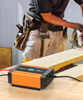 Gutsy 2000W Power Inverter Switches 12V Battery To 120V AC, displayed in use on a workbench with a power saw in action.