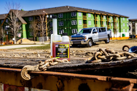 Top Shelf Diesel Fuel Additive And Daily Tune Up Formula Keeps Your Rig Running Slick Boosts Mileage And Sweeps Away Carbon Gunk For A Rock Solid Highway Cruise In A 16 Oz Bottle on a construction site.