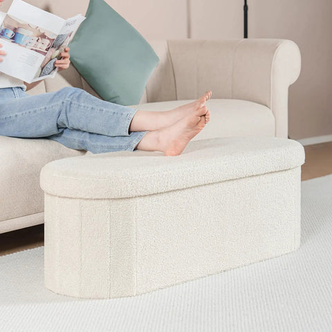 Person relaxing with feet on Go To Storage Ottoman With Cozy Sherpa Lining For Living Room Foldable Foot Rest Bench 43.3 Inch