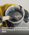 Mixing Epoxy Adhesive 2216 Gray Heat-Resistant Two-Part B/A Tube Kit in a cup with gloved hands