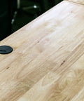 Heavy Duty Three Inch Black Floor Grommet With Tough Cover Solid ABS Plastic Cord Protector For Easy Cable Management And No Fuss Setup Keeping Your Space Spotless And Clutter Free on wooden surface.