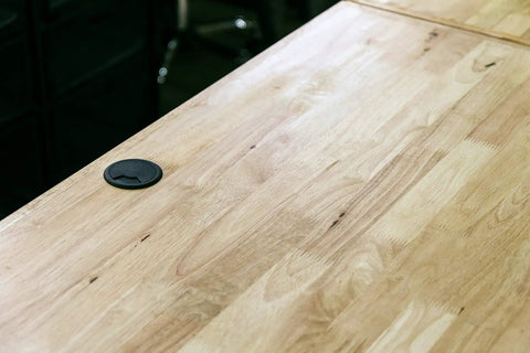 Heavy Duty Three Inch Black Floor Grommet With Tough Cover Solid ABS Plastic Cord Protector For Easy Cable Management And No Fuss Setup Keeping Your Space Spotless And Clutter Free on wooden surface.