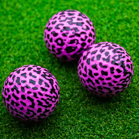 Three pink leopard print novelty golf balls arranged on grass, part of the Pink Leopard Print Novelty Golf Balls Set Of 12 For Gifts And Tournaments Standout 360 Degree Leopard Design Ideal For League Events Collectors And Ladies Golf Accessories Great For Gift Giving At Tournaments And Local Leagues.