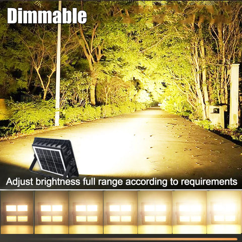 Super Bright Rechargeable Solar Work Light Packed With Huge Battery For All Your Camping Emergencies Storm Prep And Power Outages Portable Waterproof Lantern With Handy Hook And Stand Dimmable Settings Make It A Must Have showcasing adjustable brightness in a wooded area.