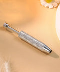 Piercing Ball Grabber Reacher Tool For Jewelry And Small Parts 4 Claw Stainless Steel Pickup Tool on beige background