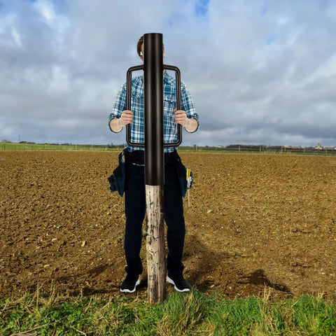 Person using 34Lb T Post Driver With Handles Pro Grade Heavy Duty Metal Fence Post Driver And Hole Digger For Wood Posts