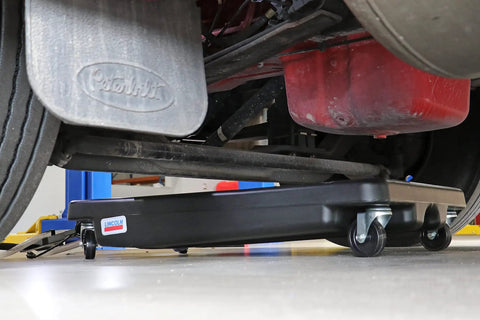 17 Gallon Low Profile Truck Drain With 120V Electric Pump positioned under truck for easy fluid cleanup with 6ft discharge hose.
