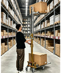 Top Rated Portable Material Lift With Manual Winch Stacker And Forks Perfect For Warehouse Jobs, user operating lift in aisle.
