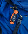 Orange 3 Pack Survival Bracelet Set With Compass, Whistle, And Magnesium Fire Starter For Camping And Hiking clipped to backpack