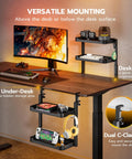2 Tier Clamp On Desk Shelf 16 Inch Wide Adjustable Above Or Under Desk Storage Holds 66 Lbs Heavy Duty Desktop Organizer With Built In Headphone Holder for gaming setup and office gear, black, shown in office setup with multiple devices