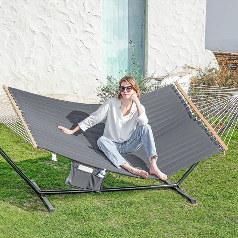 Two Person Outdoor Hammock With Heavy Duty Steel Stand 55 Inch Double Hammock Large Removable Pillow Storage Pockets Easy Setup 475 Lbs Capacity For A Chill Backyard Hangout Haze Gray, featuring woman lounging.