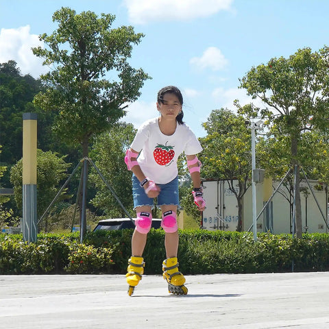 Child roller skating wearing Kids 3 In 1 Protective Gear Set with pink knee pads, elbow pads, and wrist guards, outdoor setting