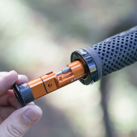 Close-up of Stash Bike Chain Tool Kit With Hidden Handlebar Storage for Quick On The Go Repairs being inserted into a bike handlebar.