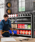 Mechanic working in garage beside heavy duty 4 tier garage shelving unit, 71 inch wide steel storage rack with tires and tools.