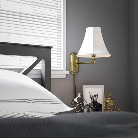 Polished Brass Wall Swing Arm Lamp With Off White Fabric Shade Delivers Classic Vibe And Traditional Style beside bedroom headboard