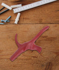 Replacement Fencing Foil Handle With Ergonomic Grip And Stainless Steel Build For Training And Comp, red grip on wood surface.