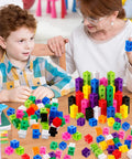 Child and teacher using 100 Piece Linking Cubes Set For Math Manipulation Colorful Counting Blocks For Classroom And Home STEM Activities