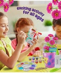 Kids using Paint And Plant Stoneware Flower Garden Kit For Kids 6 To 12 with paints, pots, tray, markers, and seeds.