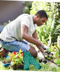 Person gardening next to Eight Piece Lawn Aerator Shoes With Solid Metal Straps For Easy Assembly And Soil Aeration.