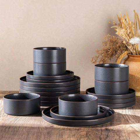 Top Tier Real Deal 12 Piece Stoneware Dinnerware Set With Sleek Matte Finish Includes Four Dinner Plates Salad Dishes And Cereal Bowls Lead Free stacked on a wooden table.