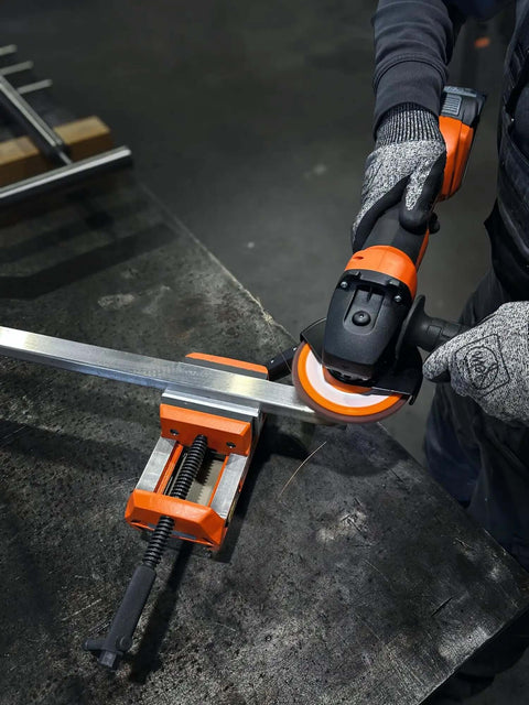 Heavy Duty Cordless Angle Grinder 115mm With Slick Brushless Motor And 18V Power For Smooth Sanding Deburring And Precision Jobsite Cutting in use on metal workpiece.