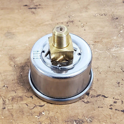 Close-up of motorcycle oil pressure gauge with chrome housing and brass 1/8 NPT fitting