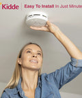 Woman installing 10 Year Photoelectric Smoke And Carbon Monoxide Alarm With Sealed Lithium Battery No Battery Change Over A Decade Kitchen Safe Combination Detector Model P3010K CO on ceiling