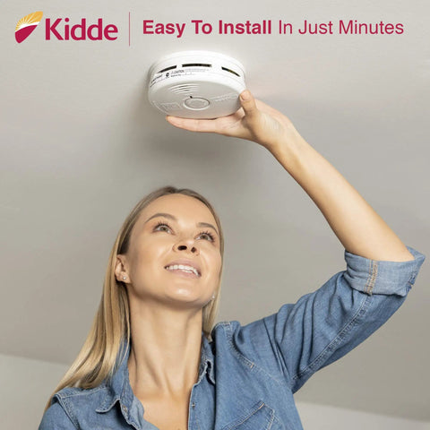 Woman installing 10 Year Photoelectric Smoke And Carbon Monoxide Alarm With Sealed Lithium Battery No Battery Change Over A Decade Kitchen Safe Combination Detector Model P3010K CO on ceiling