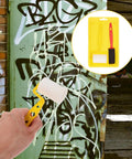 No Sweat Home Painting Kit Featuring Quick Coverage Sponge Rollers Combined With Versatile Bristle Brushes Designed For Smooth Wall Application And Relaxed Weekend Renovations with yellow sponge roller in hand.