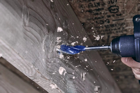 Top Rated Tri Flute Wood Drill Bit For Knocking Out Clean Holes Fast Through Lumber Builds With A Sturdy Hex Shank That Locks Tight In Any Quick Change Chuck in action, drilling through wood.