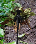 Uprooting Weeding Tool With Four Teeth removing weeds in a garden, lightweight manganese steel forged hand weeder in use