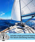 Stainless steel marine twist-lock fastener on sailboat deck with white sails in background.