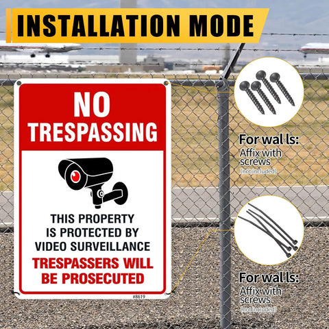 Straight Up Legal Deterrent Video Surveillance And No Trespassing Signs 4 Pack Aluminum Security Plates on a fence outdoors.