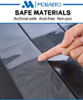 Hand pointing to a page in the Top Loader Card Binder With 18 Double Sided Pages, Holds 324 3x4 Top Loaders, Rugged Black Hard Plastic Binder