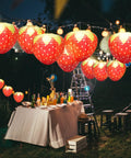 Strawberry Paper Lanterns Set Of 4 Large 8 Inch And 12 Inch Hanging Decor 3D Red Strawberry Party Lanterns displayed at outdoor night party.