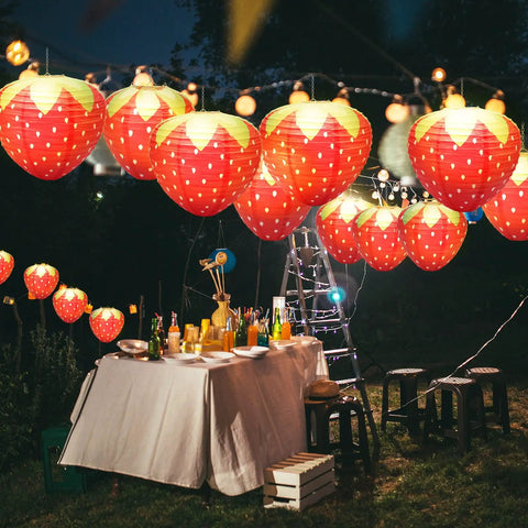 Strawberry Paper Lanterns Set Of 4 Large 8 Inch And 12 Inch Hanging Decor 3D Red Strawberry Party Lanterns displayed at outdoor night party.