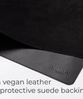 Close-up of Pebble Black Leather Desk Mat With Cable Organizer 35 By 17 Inches, Premium Vegan PU Desk Pad And Mouse Mat, felt surface.